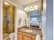 Well-lit bathroom featuring a shower and granite countertops at 10137 W Berry Dr, Littleton, CO 80127