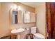 Bathroom features neutral wall color and vanity with storage for toiletries at 10137 W Berry Dr, Littleton, CO 80127
