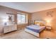 Bedroom featuring large window and stylish decor with colorful art and furniture at 10137 W Berry Dr, Littleton, CO 80127
