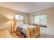 Cozy bedroom with natural light, wood frame bed and neutral carpet flooring at 10137 W Berry Dr, Littleton, CO 80127