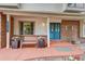 Inviting front porch with a bench, decorative planters, and a stylish blue front door at 10137 W Berry Dr, Littleton, CO 80127