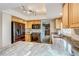 Bright kitchen with stainless steel appliances, light wood cabinetry, and stone countertops at 10137 W Berry Dr, Littleton, CO 80127