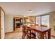 Open-concept kitchen with a dining table and access to the living area and outdoor deck at 10137 W Berry Dr, Littleton, CO 80127