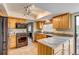 Well-lit kitchen featuring granite countertops, stainless steel appliances and beautiful wooden cabinets at 10137 W Berry Dr, Littleton, CO 80127