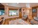 Bright living room with light wood floors, a large window and a seating area with comfortable chairs at 10137 W Berry Dr, Littleton, CO 80127
