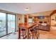 Open-concept living space with a dining table, inviting fireplace, and access to outdoor area at 10137 W Berry Dr, Littleton, CO 80127