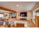 Spacious living room featuring a fireplace, wood floors, and large windows for natural light at 10137 W Berry Dr, Littleton, CO 80127