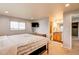 Bright main bedroom with a flat screen tv, walk-in bathroom and ample natural light at 10137 W Berry Dr, Littleton, CO 80127