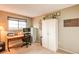 Bright office features natural light, wooden desk, modern office chair, and ample storage at 10137 W Berry Dr, Littleton, CO 80127