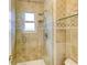 Walk in shower with glass door and tile surround at 10137 W Berry Dr, Littleton, CO 80127