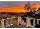 Deck view at sunset with beautiful sky, railing, and outdoor seating at 10137 W Berry Dr, Littleton, CO 80127