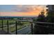 Breathtaking sunset view from a condo balcony overlooking lush greenery and scenic horizon at 7600 Landmark Way # 613-2, Greenwood Village, CO 80111