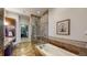 Luxurious bathroom featuring a soaking tub, glass shower, and closet at 7600 Landmark Way # 613-2, Greenwood Village, CO 80111