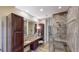 Elegant bathroom features dual sinks, custom cabinetry, and a glass-enclosed shower at 7600 Landmark Way # 613-2, Englewood, CO 80111