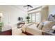 Comfortable bedroom showcasing ample natural light through large windows, ceiling fan, and neutral decor at 7600 Landmark Way # 613-2, Greenwood Village, CO 80111