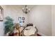 Cozy home office with chandelier lighting, desk, chair, and plants in a room with warm, neutral paint colors at 7600 Landmark Way # 613-2, Greenwood Village, CO 80111