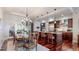Open-concept kitchen with a central island, wooden cabinets, stainless appliances and an adjacent dining area at 7600 Landmark Way # 613-2, Greenwood Village, CO 80111