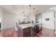 Spacious kitchen island featuring a wine cooler and stainless steel appliances, with an adjacent dining area at 7600 Landmark Way # 613-2, Greenwood Village, CO 80111