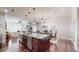 Open kitchen with a large island, bar seating and stainless appliances adjacent to a dining and living area at 7600 Landmark Way # 613-2, Greenwood Village, CO 80111