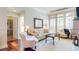 Elegant living room with hardwood floors, neutral tones, and an open doorway to a luxurious bathroom at 7600 Landmark Way # 613-2, Greenwood Village, CO 80111