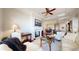 Cozy living room with fireplace, hardwood floors, and open view to the dining and kitchen area at 7600 Landmark Way # 613-2, Greenwood Village, CO 80111