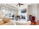 Bright living room with fireplace, hardwood floors, and large windows offering natural light at 7600 Landmark Way # 613-2, Greenwood Village, CO 80111