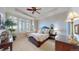 A traditionally styled main bedroom featuring large windows with shutters and a ceiling fan at 7600 Landmark Way # 613-2, Greenwood Village, CO 80111