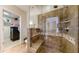 Walk-in shower with glass door features custom tile, a built-in seat, and a rainfall shower head at 7600 Landmark Way # 613-2, Greenwood Village, CO 80111