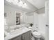 Bright bathroom featuring white tile, marble vanity, and a shower-tub combination at 7369 S Gore Range Rd # 208, Littleton, CO 80127