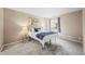 Comfortable bedroom with neutral tones, soft carpet, and natural light from the window at 7369 S Gore Range Rd # 208, Littleton, CO 80127
