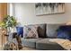 Close up of comfortable gray couch with decorative pillows and stylish decor at 7369 S Gore Range Rd # 208, Littleton, CO 80127