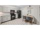 Kitchen with eat-in space featuring white cabinets and modern black appliances at 7369 S Gore Range Rd # 208, Littleton, CO 80127