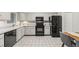 Bright kitchen with white cabinets and modern black appliances at 7369 S Gore Range Rd # 208, Littleton, CO 80127