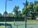 Well-maintained tennis court surrounded by lush trees, perfect for outdoor recreation at 7369 S Gore Range Rd # 208, Littleton, CO 80127