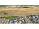 Aerial view of a residential area near open fields and a pond at 5925 Hanover St, Denver, CO 80238