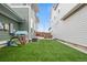 Green backyard has artificial turf between two houses; includes a playhouse at 5925 Hanover St, Denver, CO 80238