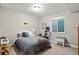 Minimalist bedroom setup including a bed, peloton and play area providing an inviting space for relaxation and exercise at 5925 Hanover St, Denver, CO 80238