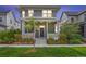 Charming home featuring manicured lawn and inviting front porch at 5925 Hanover St, Denver, CO 80238