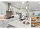 Modern kitchen boasts stainless steel appliances and quartz countertops with barstool seating at 5925 Hanover St, Denver, CO 80238