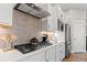 Well-equipped kitchen with stainless steel appliances, white cabinetry, and a modern backsplash at 5925 Hanover St, Denver, CO 80238