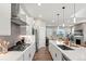 Stylish kitchen features stainless steel appliances, a center island, and hardwood floors at 5925 Hanover St, Denver, CO 80238