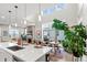 Open-concept living space with modern kitchen and dining area, filled with natural light at 5925 Hanover St, Denver, CO 80238