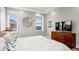 Sunny main bedroom features a tray ceiling, multiple windows, and modern decor at 5925 Hanover St, Denver, CO 80238