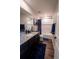 Stylish bathroom with granite countertops, dark cabinets, a tub with shower and attractive blue accents at 676 Hearthstone Ave, Brighton, CO 80601