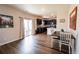 Charming dining area with dark wood cabinets, hardwood floors, and backyard access at 676 Hearthstone Ave, Brighton, CO 80601