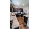 Modern kitchen features stainless steel appliances, granite countertops, and dark wood cabinets at 676 Hearthstone Ave, Brighton, CO 80601