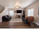 Comfortable living room with a ceiling fan, lots of natural light, and stairs to the second floor at 676 Hearthstone Ave, Brighton, CO 80601