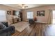 Bright living room features a ceiling fan and a sliding glass door to the backyard at 676 Hearthstone Ave, Brighton, CO 80601