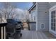 Back deck with grill, gray house with white trim, and fenced yard at 14656 W Vassar Dr, Lakewood, CO 80228