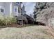 View of the house's exterior, including a deck and lush greenery at 14656 W Vassar Dr, Lakewood, CO 80228
